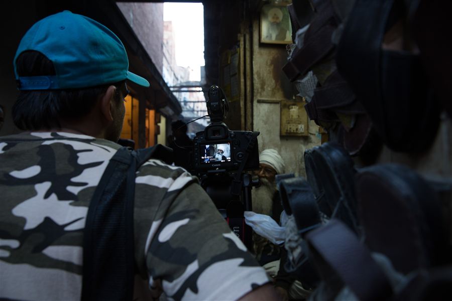 Filming an interview in a narrow old-city lane